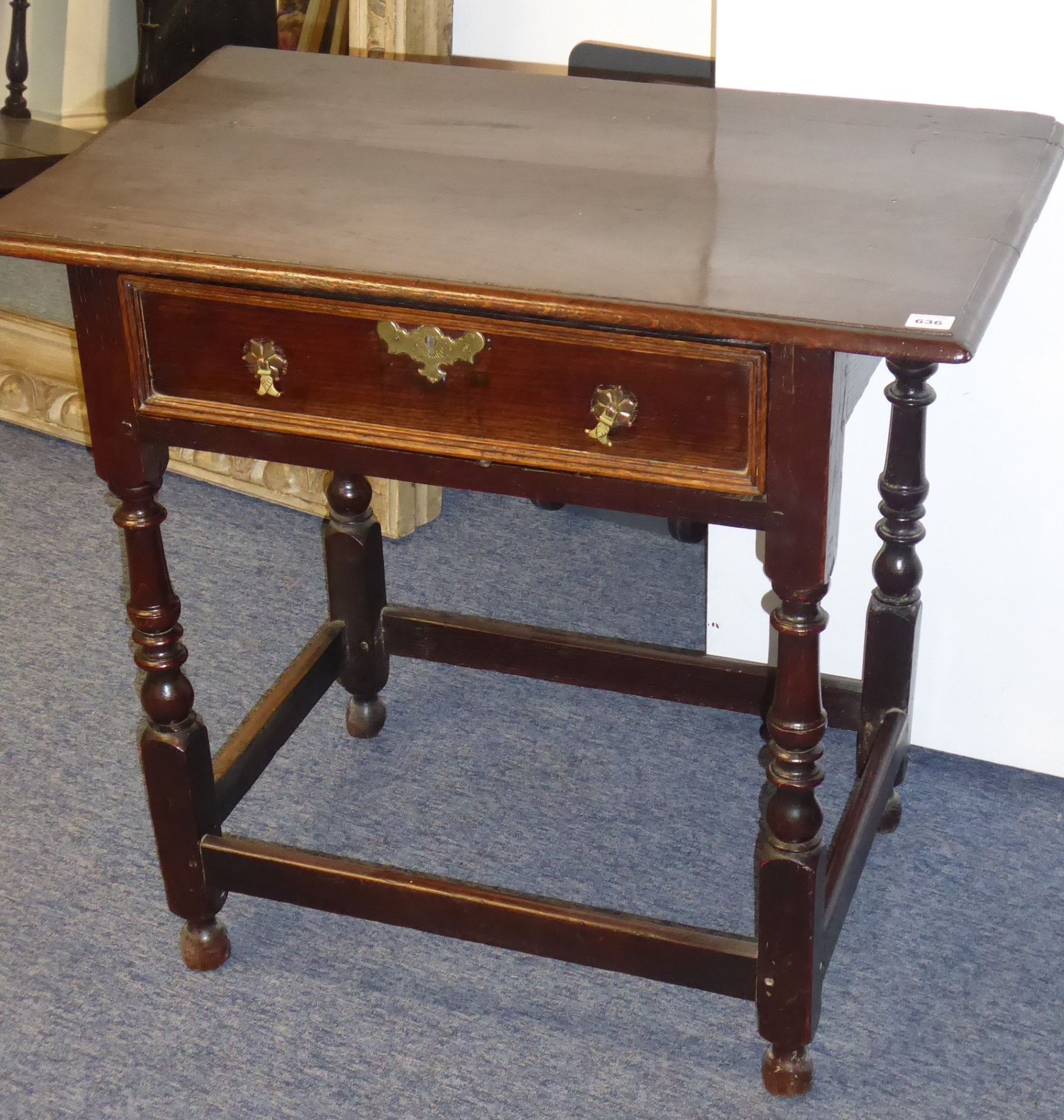 An early-18th century oak side table;