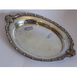 A hallmarked silver dish of oval form; the raised border decorated in the Celtic style;