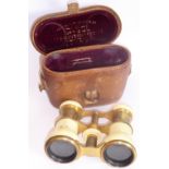 A late 19th/early 20th Century leather cased pair of ivory and gilt metal mounted opera glasses,