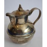 An unusual heavy white-metal Jersey-style milk jug;