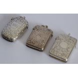 Three 19th century hallmarked silver vesta cases; each engraved with scrolling foliage,