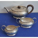 A heavy hallmarked silver early 20th century three-piece tea service comprising teapot,