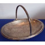 A late 19th century Continental white-metal cake basket; oval and with swing handle,