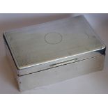 An early 20th century cedar wood lined silver cigarette box;