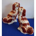 A pair of large 19th century Staffordshire spaniels; russet markings and with gold collar and lead,