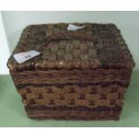 A small wicker sewing box.