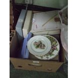 A box of collectors plates.