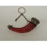 A Victorian cranberry glass and silver metal horn shaped scent bottle, the glass body with cut
