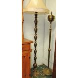 A 20th century brass standard lamp and another similar in oriental style, both 140cm high.