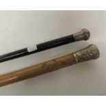 A malacca cane with decorative white metal pommel embossed with Devonshire Regt. crest together with