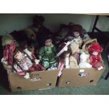 Two boxes of assorted dolls in various outfits.