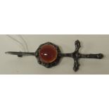 A Scottish silver brooch in the form of a sword and circular shield with a cabochon carnelian,