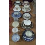 A collection of tea cups and saucers together with tea bowl and three other cups.