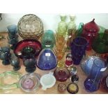 A large collection of coloured glass paperweights, vases, bowls, drinking glasses etc.