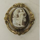 A Victorian cameo/plaited hair brooch in decorative gilt metal mount, the shell carved with Hebe and