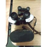 A pair of cased binoculars together another and two pairs of opera glasses.