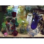 A large collection of assorted glassware including large blue and clear glass ewer etc.