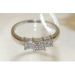 An 18ct white gold large size ring, set with three panels of four square cut diamonds, size W.