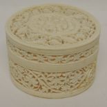 An early 20th Century carved ivory container and cover, the whole with intricately carved and