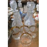 Three cut glass decanters , a claret jugs and four glasses.