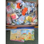 An assorted quantity of McDonalds toys, boxes and a display poster.