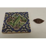 A Chinese carved coquilla nut sampan, 4.75cms long together with a glazed tile approx 10cms