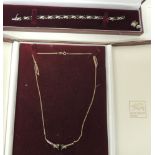 A boxed 9ct gold pendant piece on fine curb link chain, set with a central dark topaz stone and with