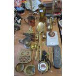 A brass shell casing with pie crust rim, two metal candlesticks and other items of metalware.