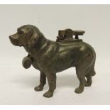 A novelty cast metal table lighter in the form of a standing St Bernard dog with barrel, 9.5cms