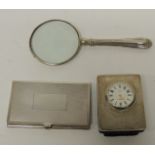 A modern silver cased, small desk clock (quartz); a silver handelled magnifying glass; and an engine