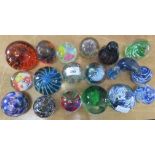 Fifteen glass paperweights together with a glass polar bear etc.