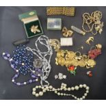 A collection of costume jewellery to include necklaces, beads and brooches; with other decorative