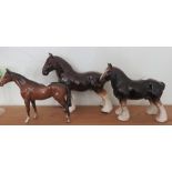 A Beswick figure of a standing horse, together with two other horse figures.