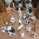 A Sylvac figure of a sitting spaniel, together with twenty other figurines of dogs and cats (21).