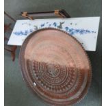 A large metal decorative tray with stand together with a coffee decorated with flowers.