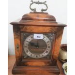 A cased mantle clock.