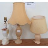 A white onyx lamp base, and two other lamp bases with shades.