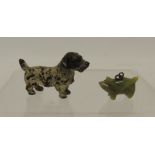 A small cold painted bronze figure of a terrier, 2.5cms high together with a miniature green jade