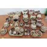 A large quantity of mottoware to include teapots, biscuit barrels, sugar bowls, etc.; some pieces