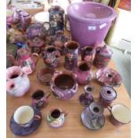 A purple glazed Longpark Torquay teapot decorated with large open pink flowers together with other