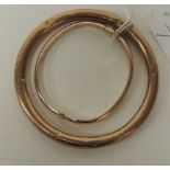 A 9ct gold hollow, slave bangle, 14g approx.; and a hollow 9ct gold bangle with engraved decoration,