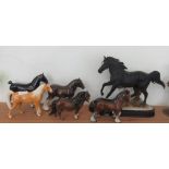 A Beswick figure of a standing black horse, god stamp 'CH Black Magic'; together with five other