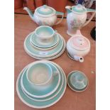 A Susie Cooper part tea service decorated in pastel shades with floral decoration.