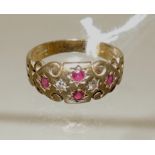 A 9ct gold dress ring set with four small rubies and two white sapphires, size L, 2.7g approx.