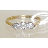An 18ct gold and platinium mounted three stone diamond ring, size N.
