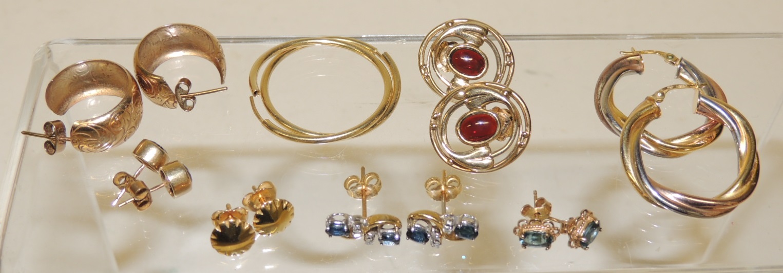A pair of 9ct three coloured gold hoop twist pierced earrings; a pair of 9ct hoops; a pair of 9ct