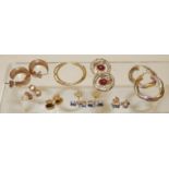 A pair of 9ct three coloured gold hoop twist pierced earrings; a pair of 9ct hoops; a pair of 9ct