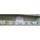 An Aynsley part tea service decorated in pink, grey and green.