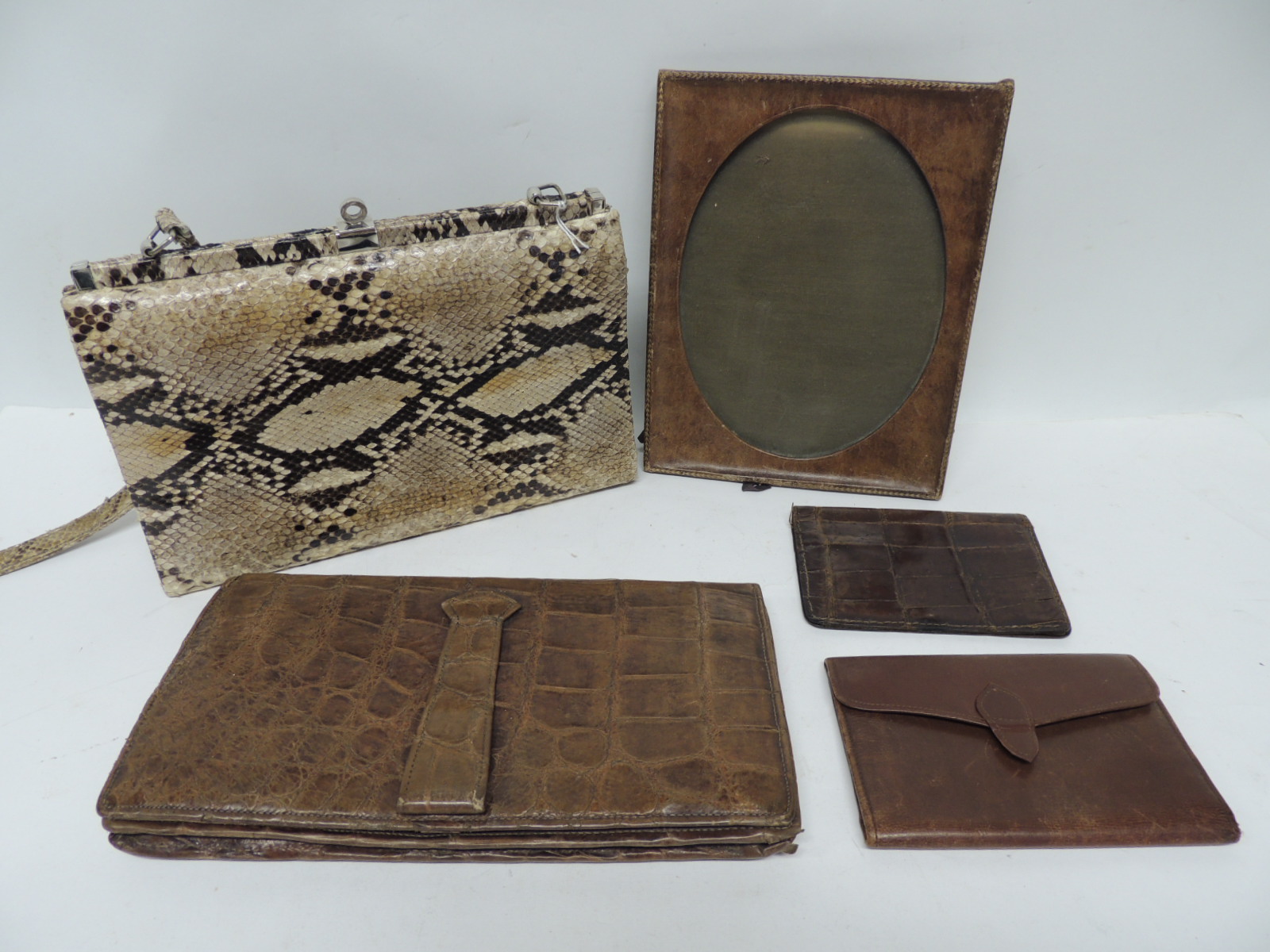 A vintage brown crocodile skin clutch bag; a python skin handbag; vintage crocodile wallet;