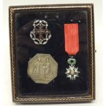 An interesting WWI period leather display case containing a miniature French Legion d'Honneur an